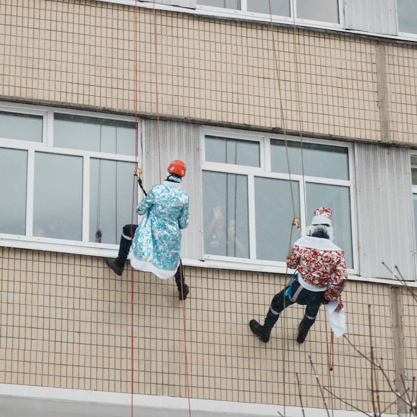 Добровольцы-спасатели спустились с крыши здания в костюмах Дедов Морозов и Снегурочек